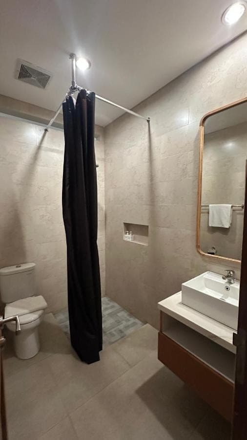 a bathroom with a shower curtain and a sink at Sekuta 36 in Sanur