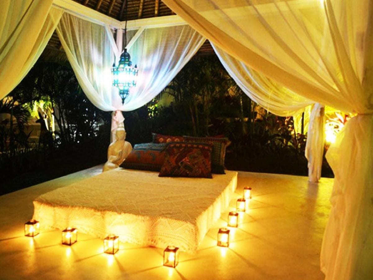 a bedroom with a bed with lights on the floor at Sal Secret Spot in Uluwatu