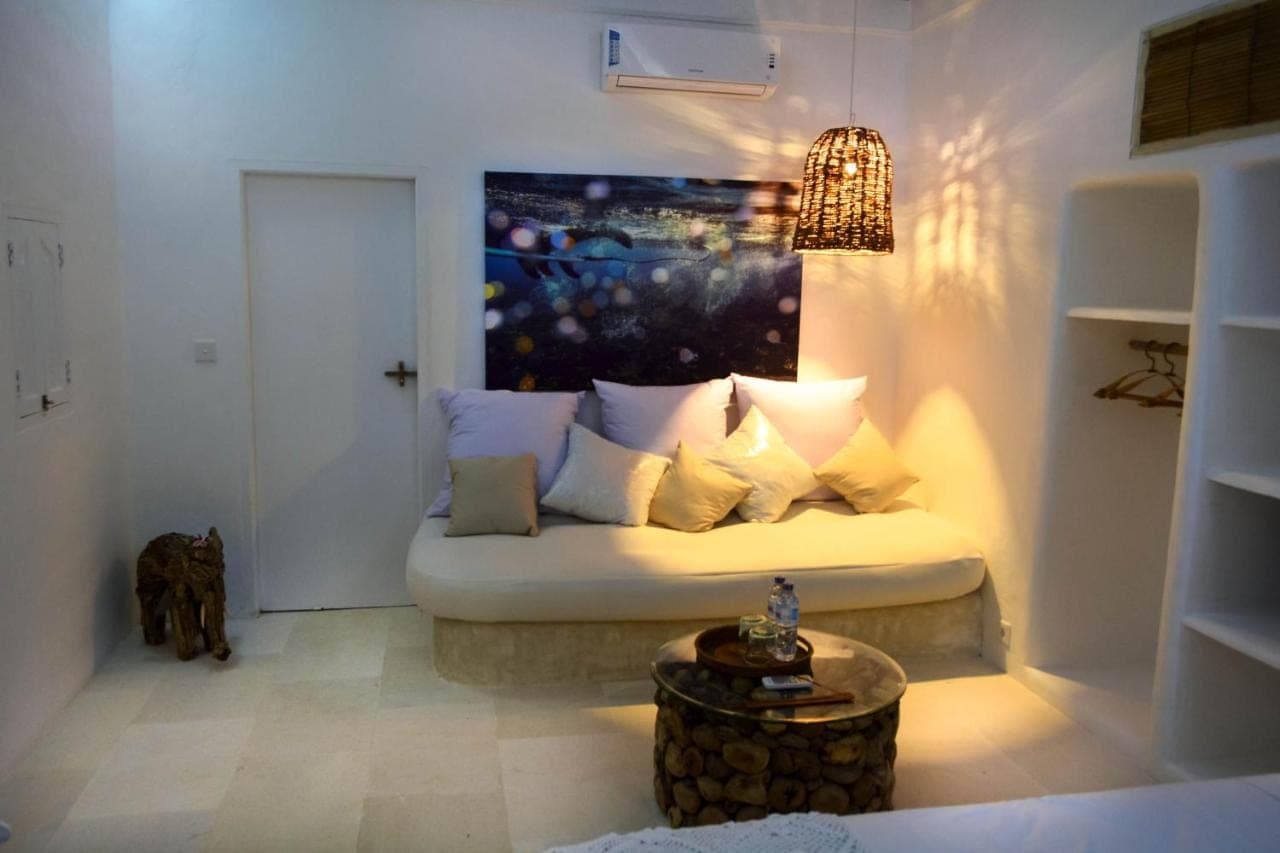 a room with a couch with a painting on the wall at Sal Secret Spot in Uluwatu