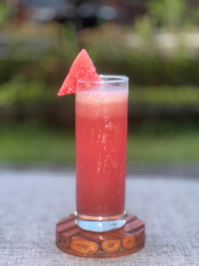 a drink with a red drink with a piece of paper at Pondok Wana Ubud in Ubud