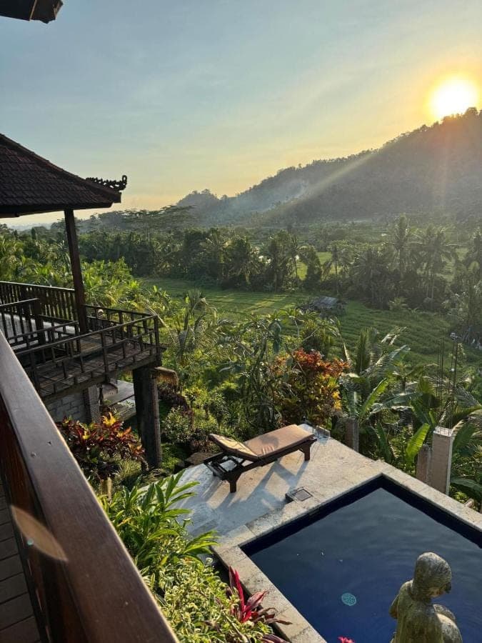 a resort with a pool and a view of a mountain at Beji Ayu Villas Sidemen in Sidemen