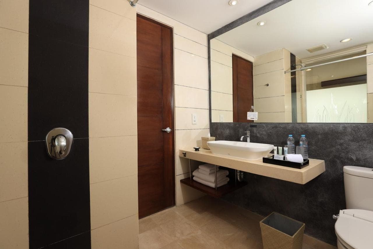 a bathroom with a sink and a mirror at Amadea Resort & Villas Seminyak Bali in Seminyak