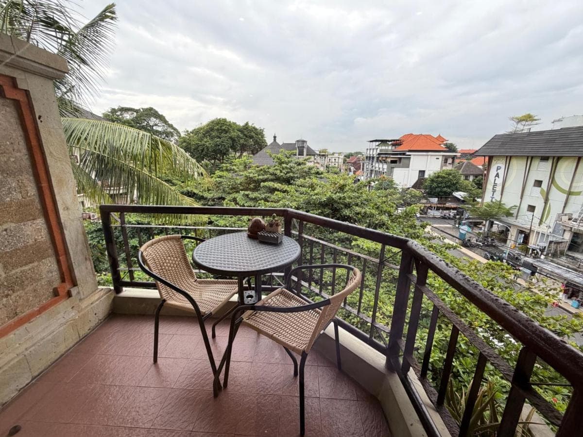 a table and chairs on a balcony with a view at Private Apartment 6505 at the Jayakarta Residence in Seminyak