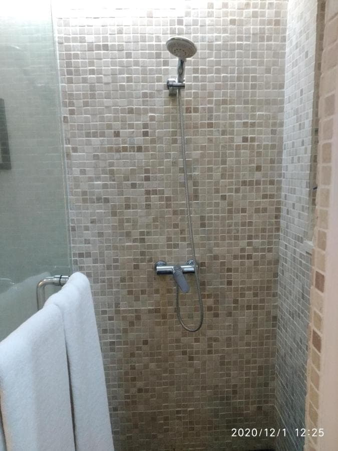 a shower with a shower head in a bathroom at Allia Residence in Nusa Dua