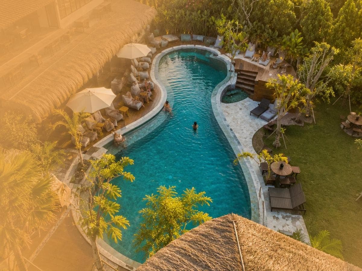 an overhead view of a swimming pool at a resort at White Penny Bali in Seminyak