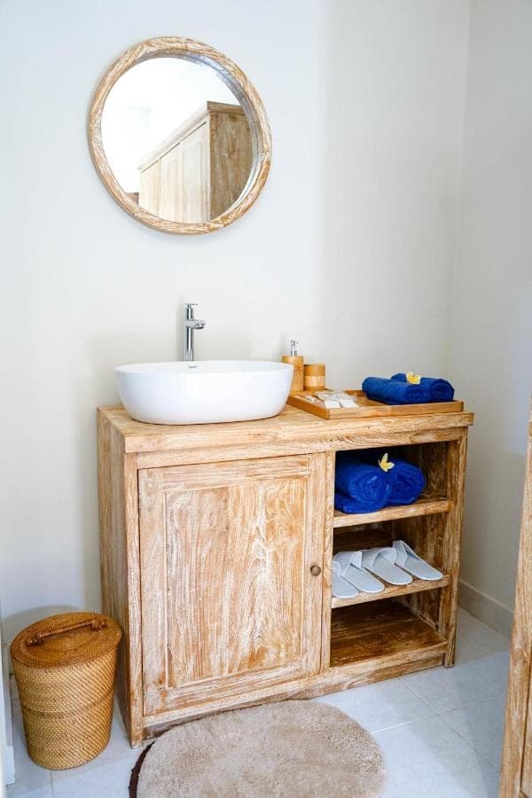 a bathroom with a sink and a mirror at Adhi Homestay in Nusa Dua