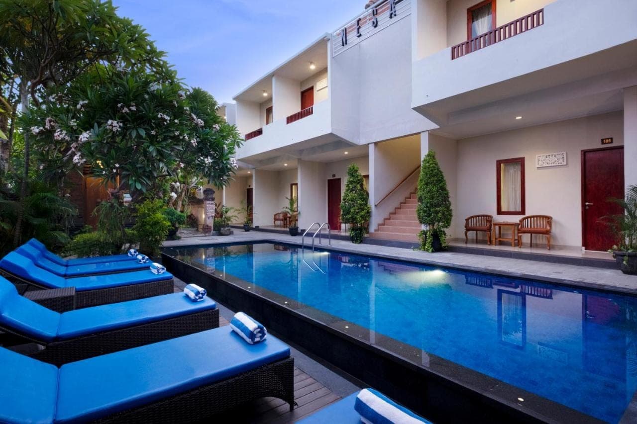 a swimming pool in the middle of a hotel at Nesa Sanur Bali in Sanur
