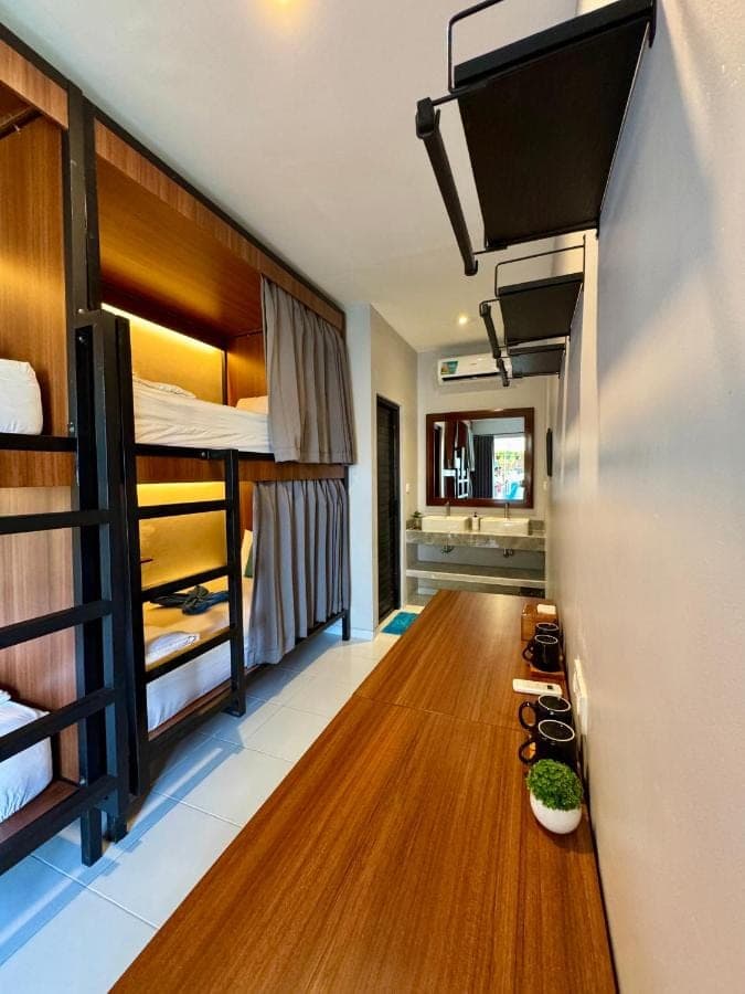 a room with bunk beds and a wooden floor at WISH Stay-Surf-Relax in Uluwatu
