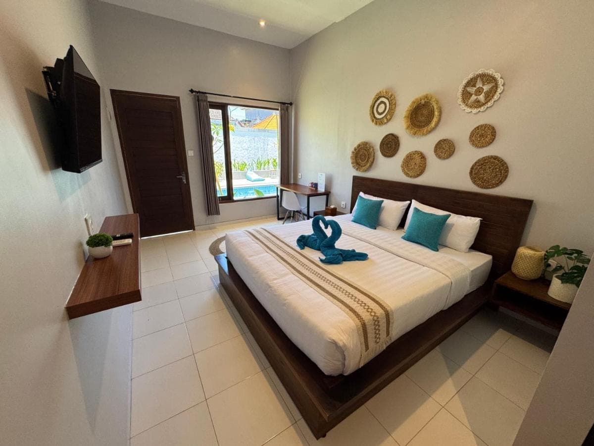 a bedroom with a large bed with a blue animal on it at WISH Stay-Surf-Relax in Uluwatu