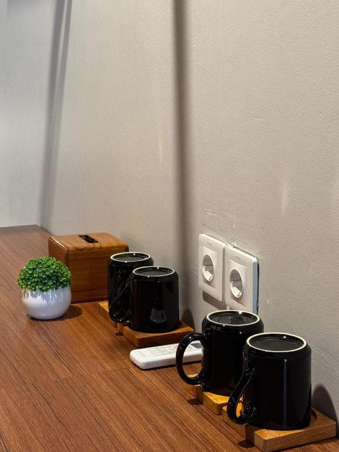 a group of black coffee cups sitting on a table at WISH Stay-Surf-Relax in Uluwatu