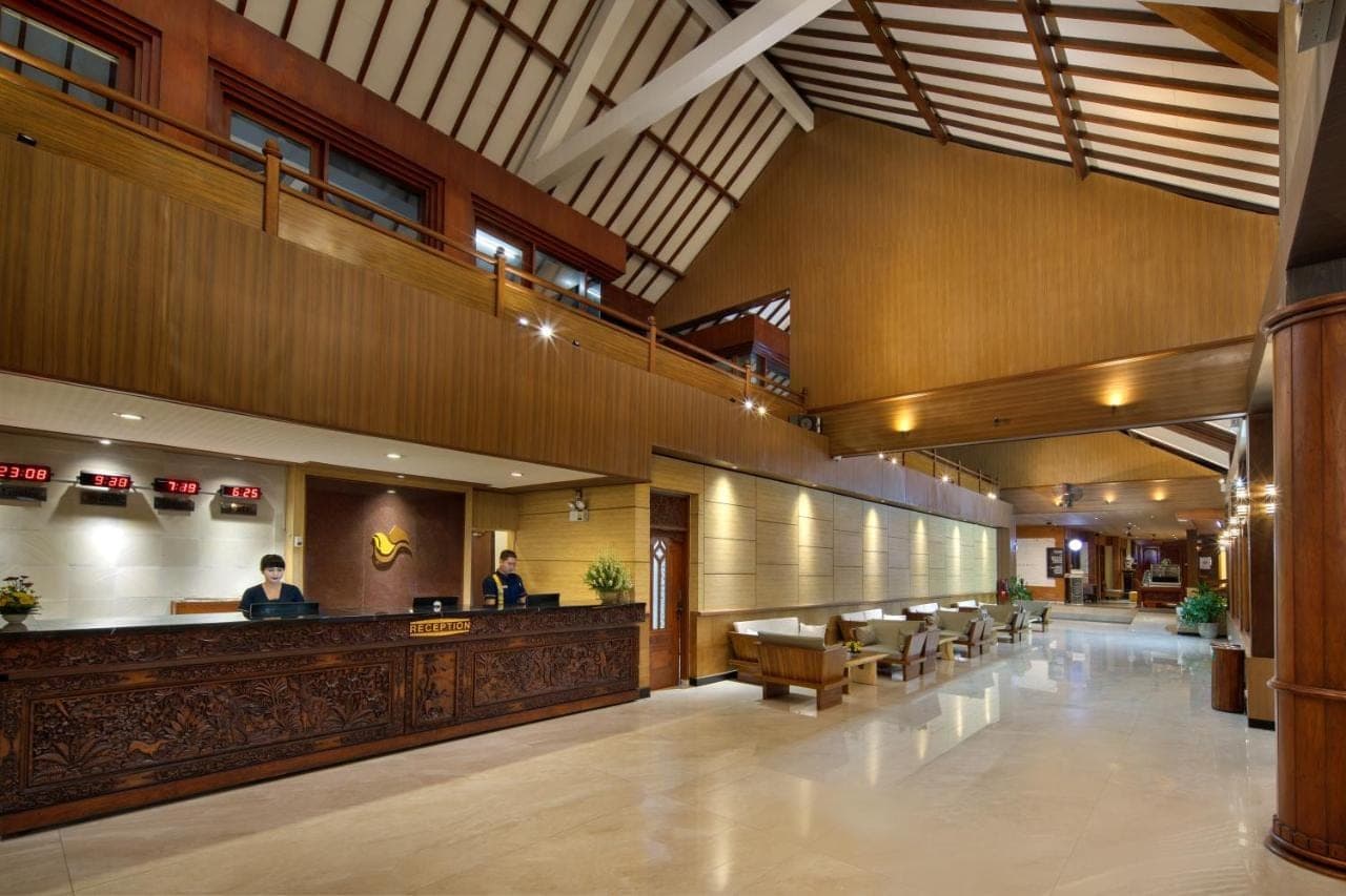 a lobby of a hospital with a bar and people at Grand Istana Rama Hotel in Kuta