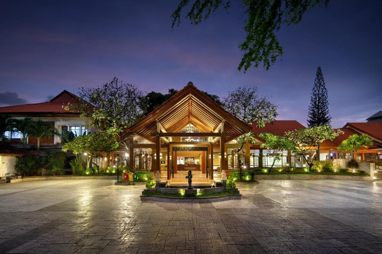 a large building with a courtyard at night at Grand Istana Rama Hotel in Kuta