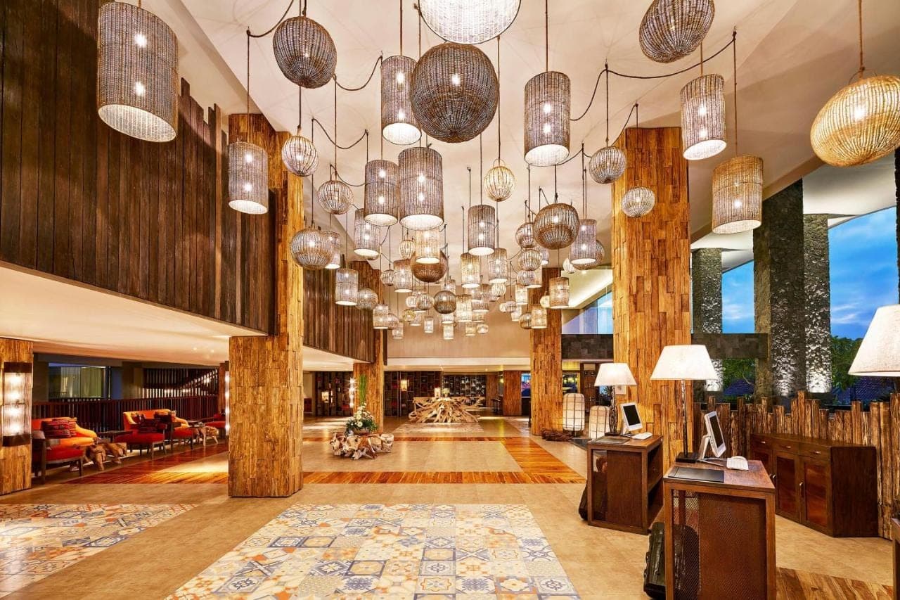 a lobby with many chandeliers in a building at Four Points by Sheraton Bali, Kuta in Kuta