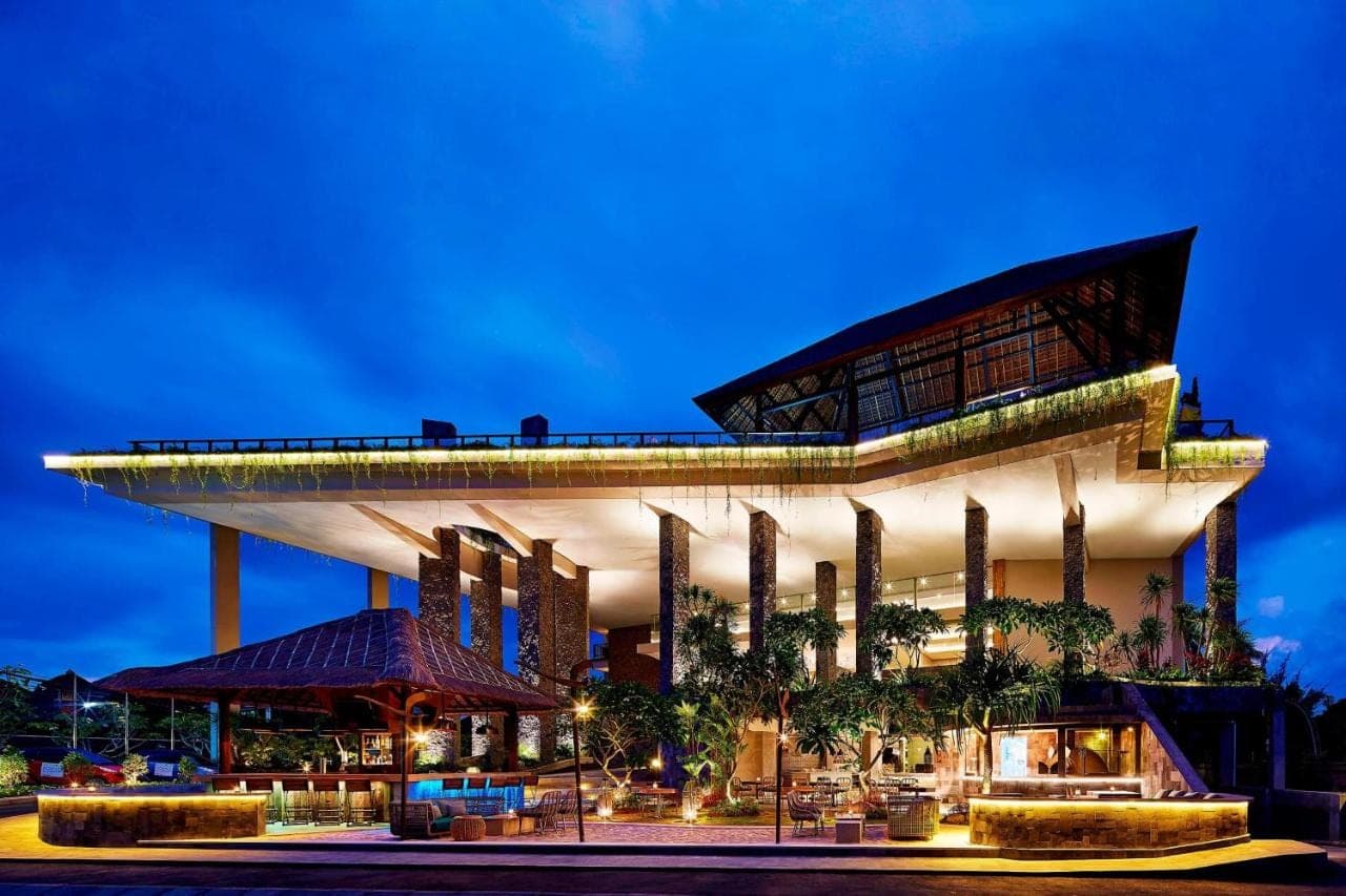 a large building with a tower on top of it at Four Points by Sheraton Bali, Kuta in Kuta