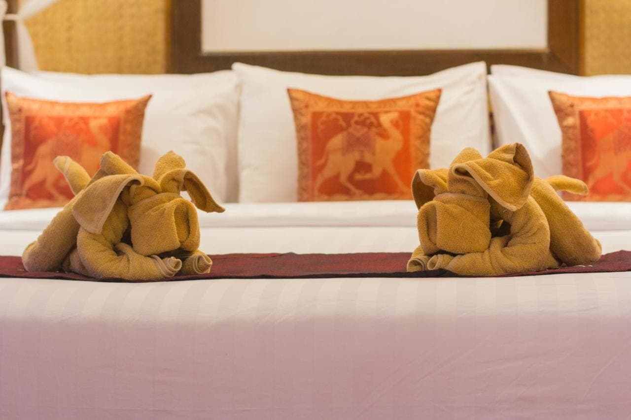 two stuffed animals are sitting on a bed at Ubud Terrace in Ubud