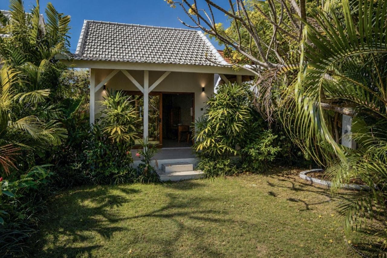 a small house with a pathway leading to it at Lunatica Bali in Uluwatu