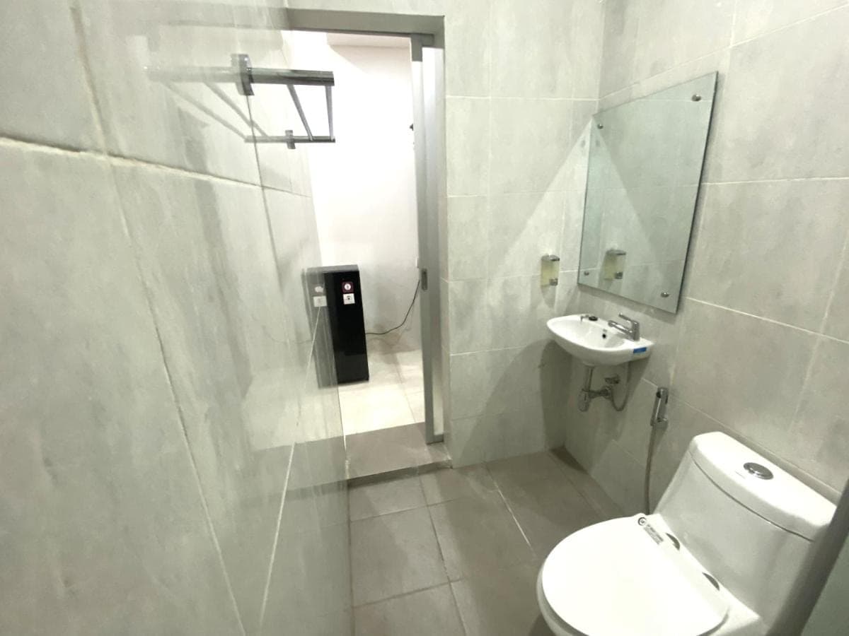 a bathroom with a toilet and a sink at Bidadari Homestay Nusa Dua in Nusa Dua