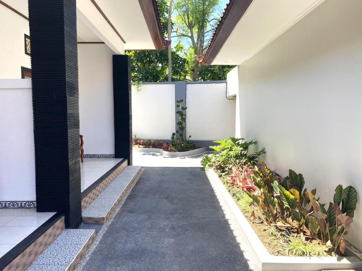 a hallway of a house with a driveway at Bidadari Homestay Nusa Dua in Nusa Dua