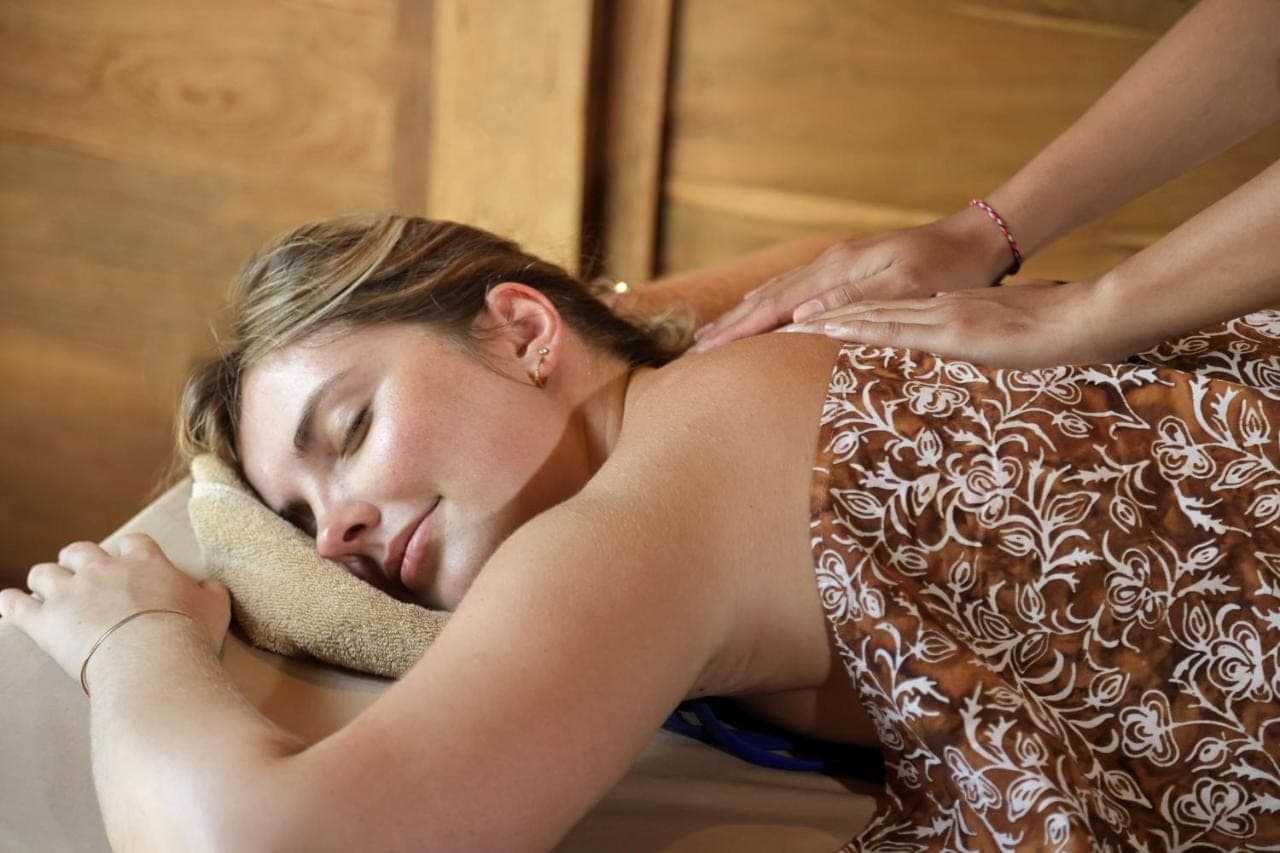 a woman getting her hair brushed by a therapist at Devani Resort Sidemen in Sidemen