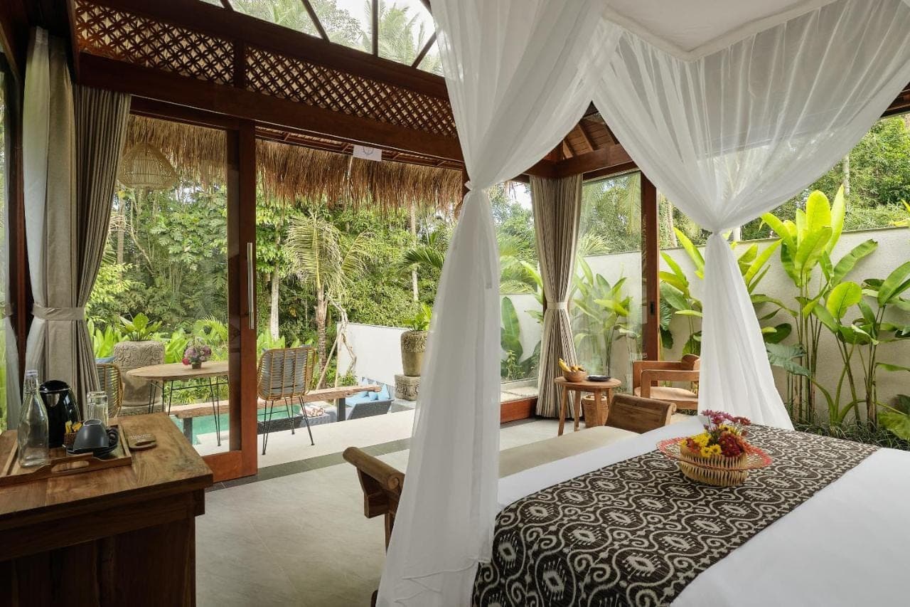 a bedroom in a villa with a bed at Changi Jungle Ubud Villas in Ubud