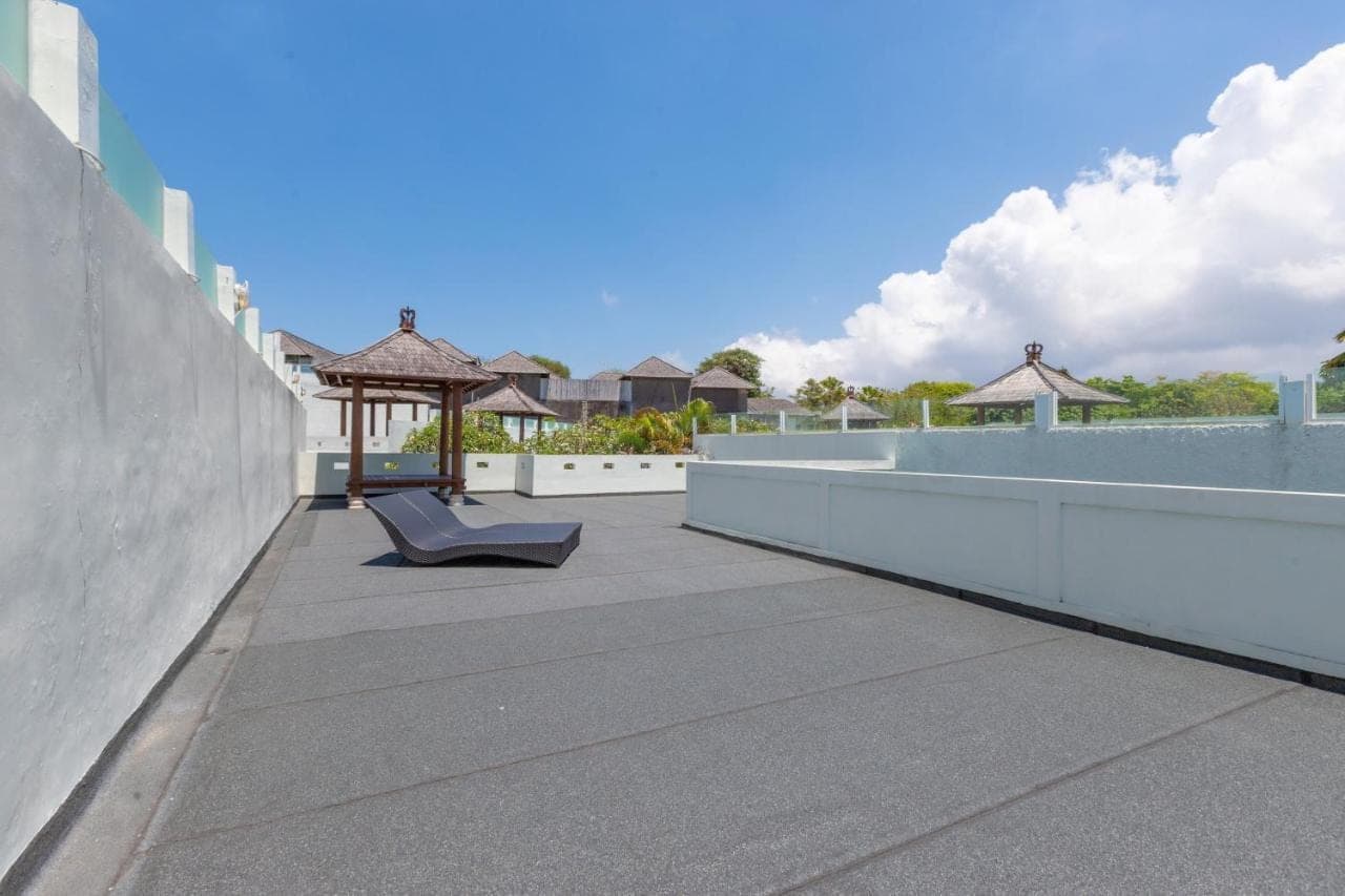 a patio with a bench and a gazebo on a building at Nunamkhalu Private Villa and Spa in Nusa Dua