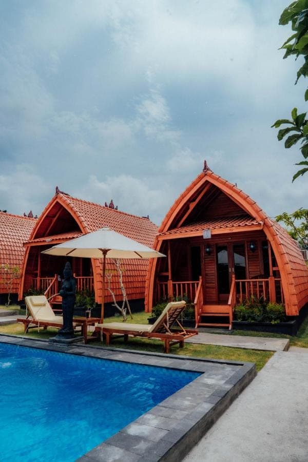 a resort with a swimming pool and a house at Nusa Dua Huts Pondok Gajah Para by EPS in Nusa Dua