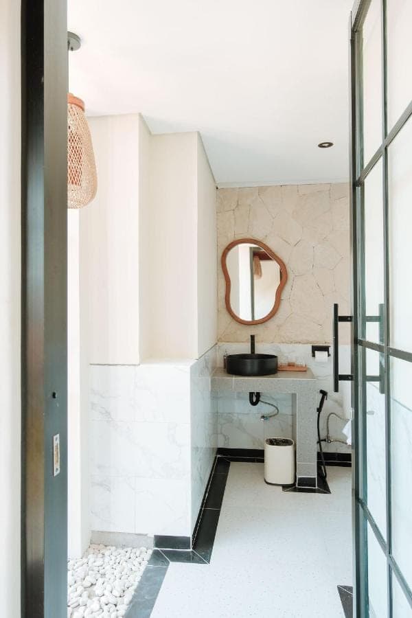 a bathroom with a sink and a mirror at Mattea Guest House Nusa Dua Bali in Nusa Dua
