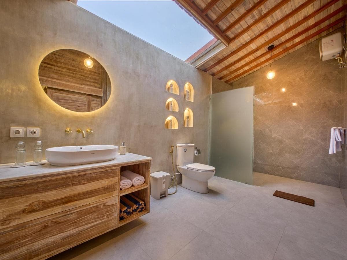 a bathroom with a sink and a toilet at Uluwatu Desa in Uluwatu