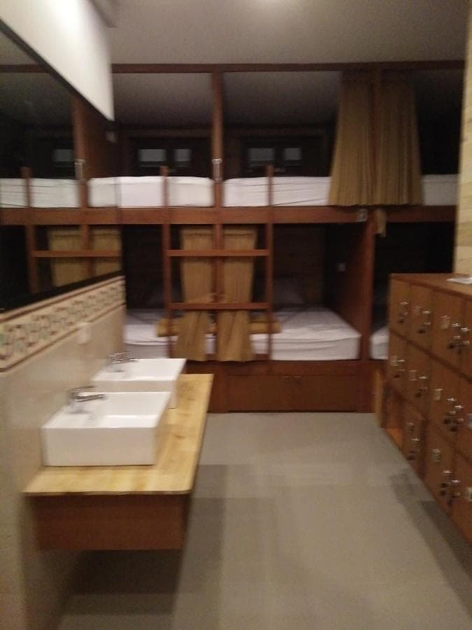 a room with bunk beds with a sink in it at Made House Homestay and Dormitory in Sanur