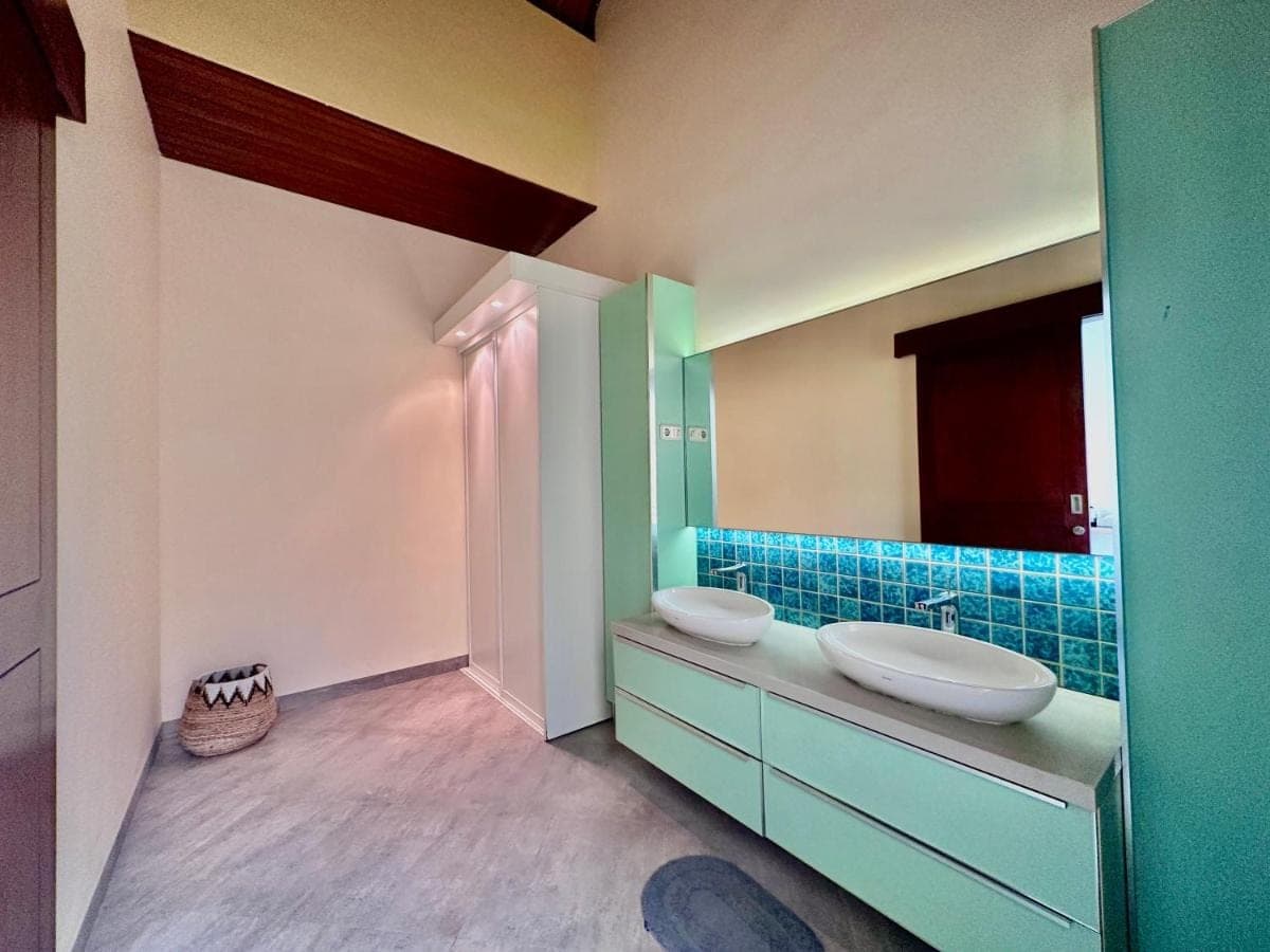 a bathroom with two sinks and a mirror at Sanur ocean view villas in Sanur