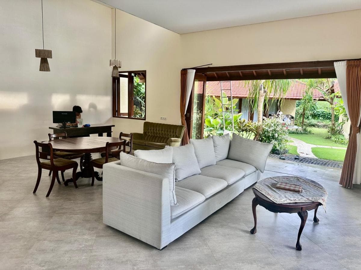 a living room with a white couch and a table at Sanur ocean view villas in Sanur
