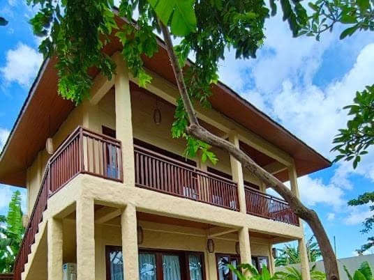 a building with a balcony on top of it at Sanur ocean view villas in Sanur