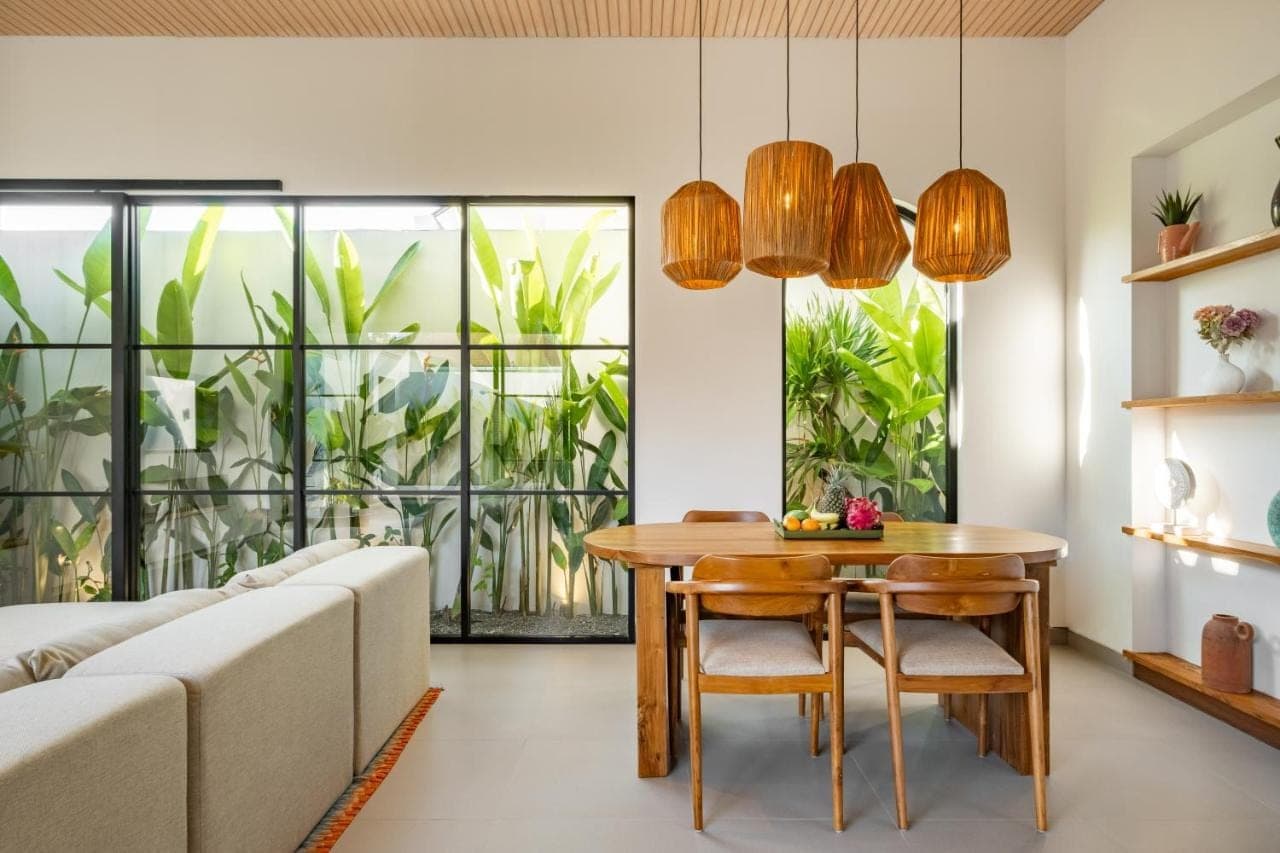 a living room with a table and a couch at CHAO Villas Rooms Recovery Spa in Uluwatu