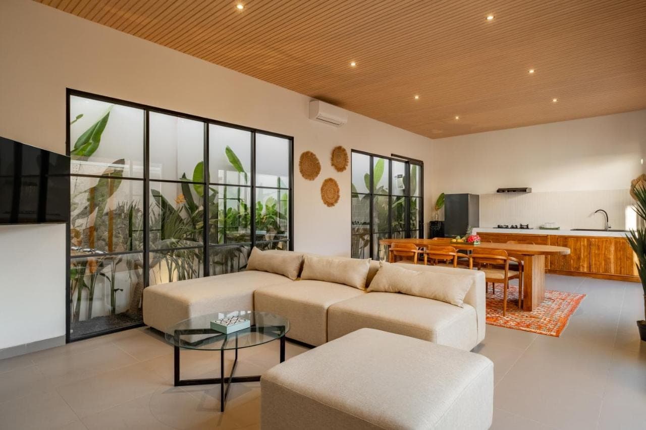 a living room with a couch and a table at CHAO Villas Rooms Recovery Spa in Uluwatu