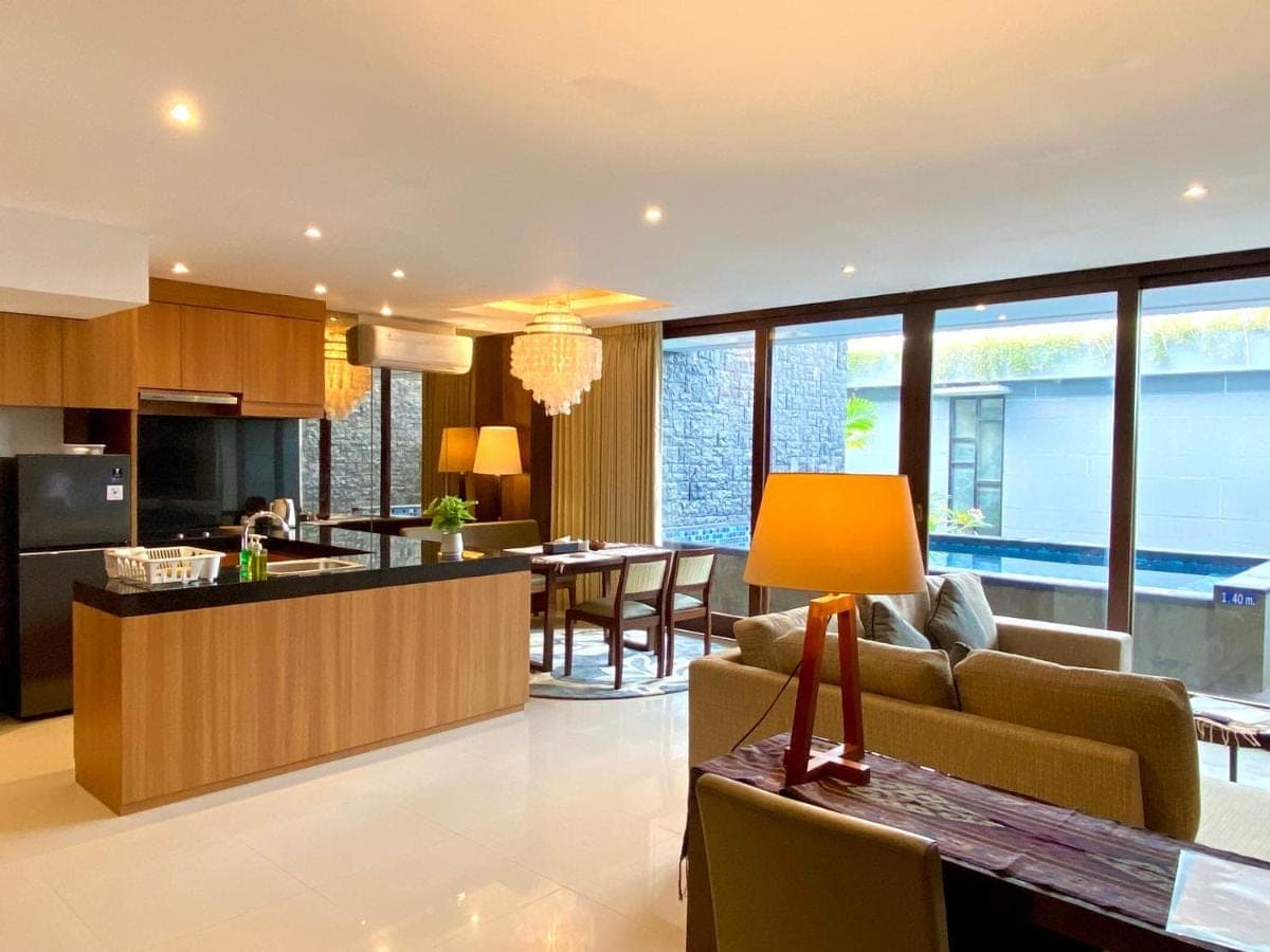 a living room and kitchen with a couch and a table at Bloomingville Villas in Nusa Dua in Nusa Dua