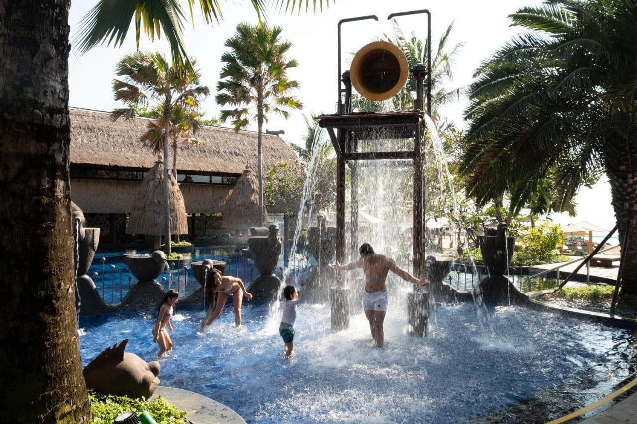 a group of people playing in a water park at Holiday Inn Resort Bali Nusa Dua by IHG in Nusa Dua