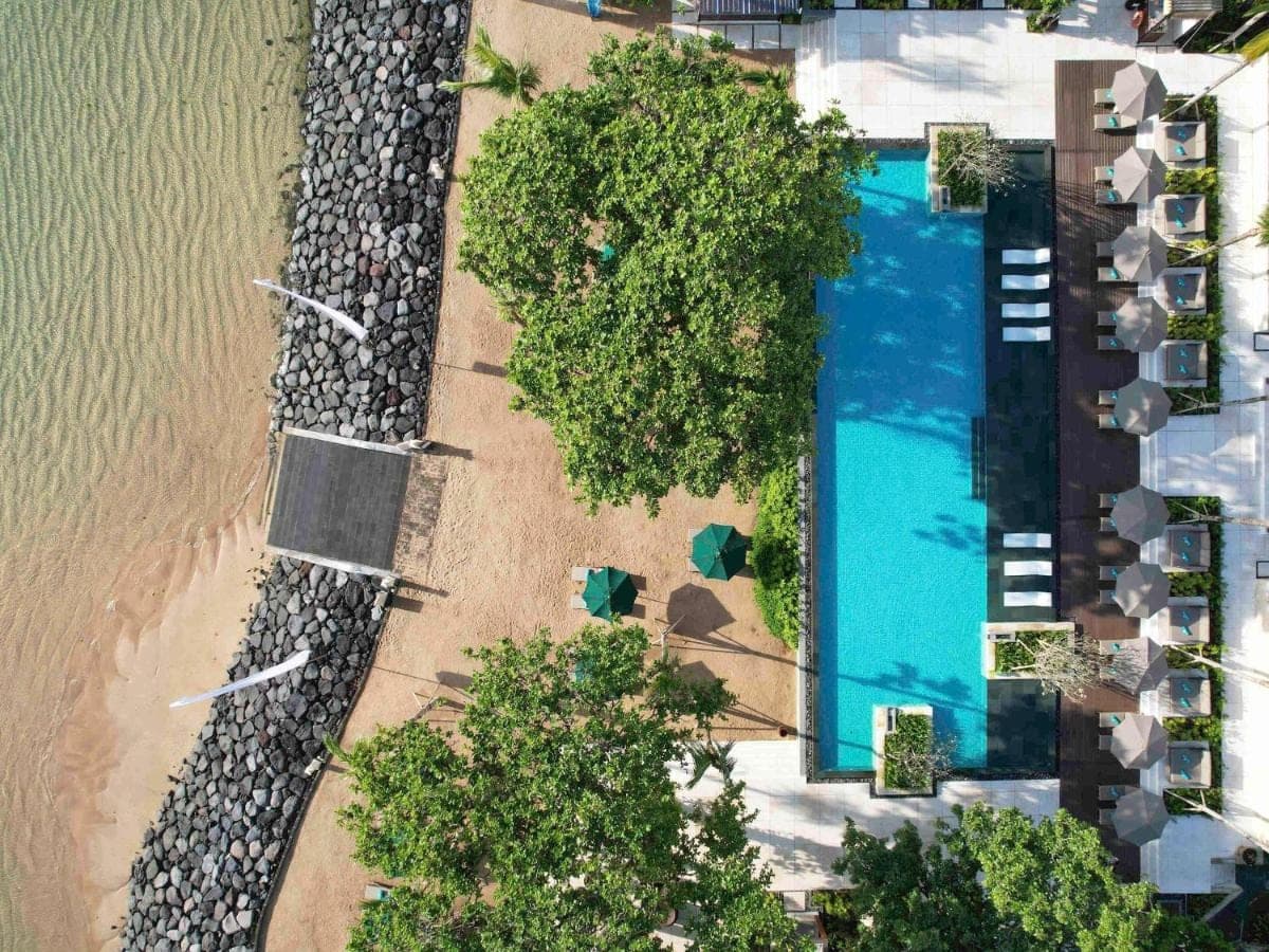 an overhead view of a swimming pool next to a beach at Novotel Bali Benoa in Nusa Dua