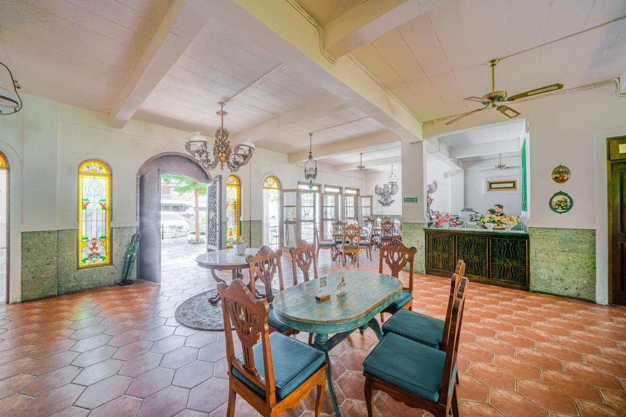 a dining room with a table and chairs at Pitaloka Hotel Sanur By DeWizZ Management in Sanur