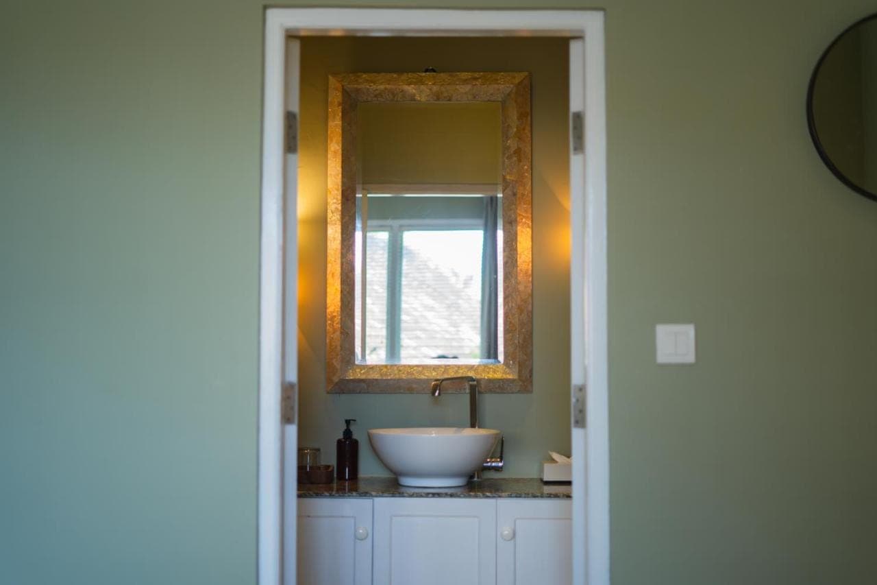 a bathroom with a sink and a mirror at Room Sweet Room - Seminyak Center, walk to the Beach in Seminyak