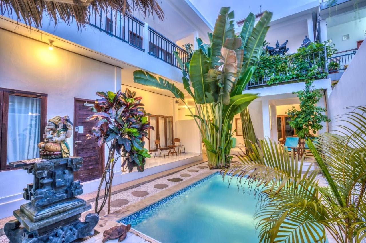 a swimming pool in the middle of a house with plants at Villa iris Homestay in Uluwatu