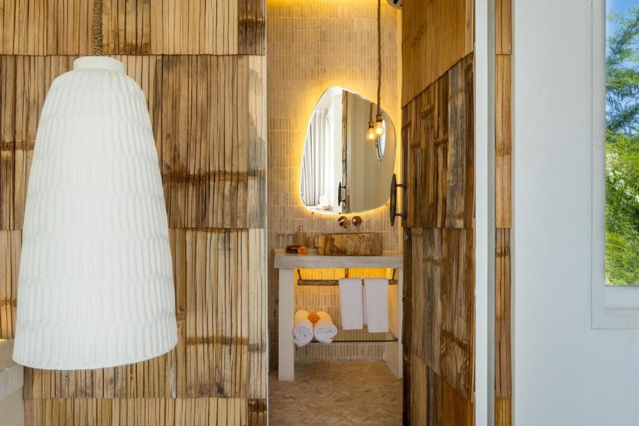 a bathroom with a sink and a mirror at Gravity Boutique Suites in Uluwatu