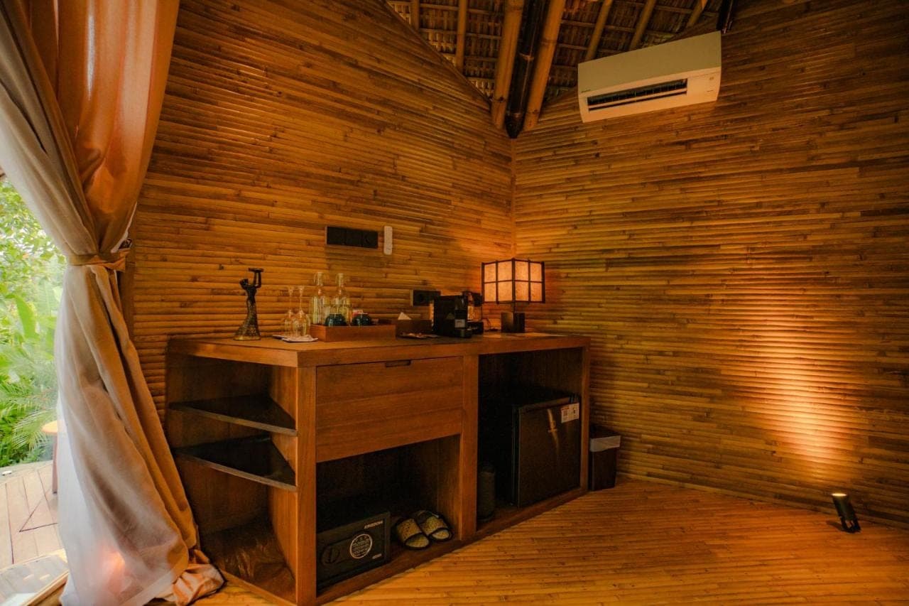 a room with a wooden wall with a desk in it at Atamendra Bali Resort at Sidemen in Sidemen