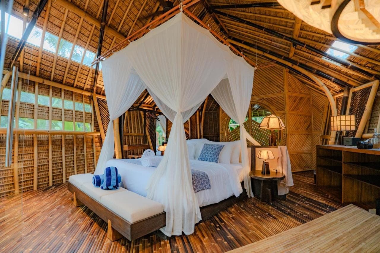 a bedroom with two beds in a tent at Atamendra Bali Resort at Sidemen in Sidemen