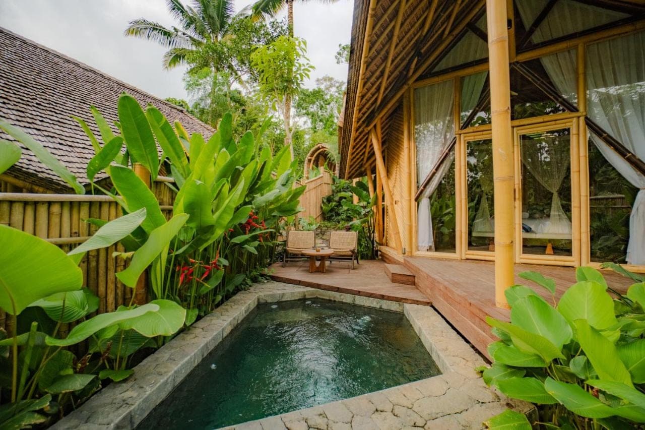 a house with a pool in the middle of a garden at Atamendra Bali Resort at Sidemen in Sidemen
