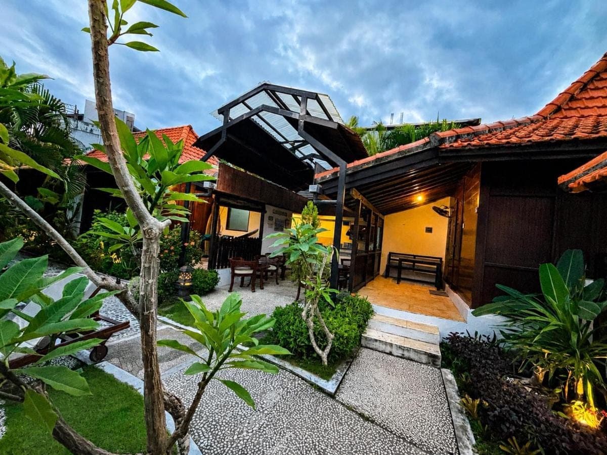 a house with a courtyard with a building at Surfer Paradise Villas Bali in Canggu
