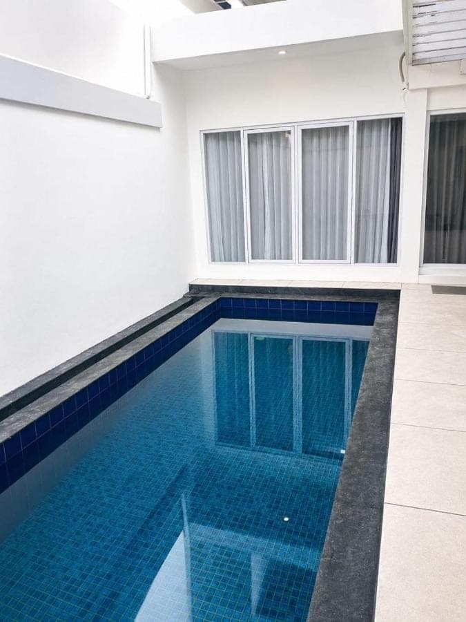a swimming pool in a house with blue tiles at Nusa Dua Oasis Elara 2BR Private Pool Villa in Nusa Dua