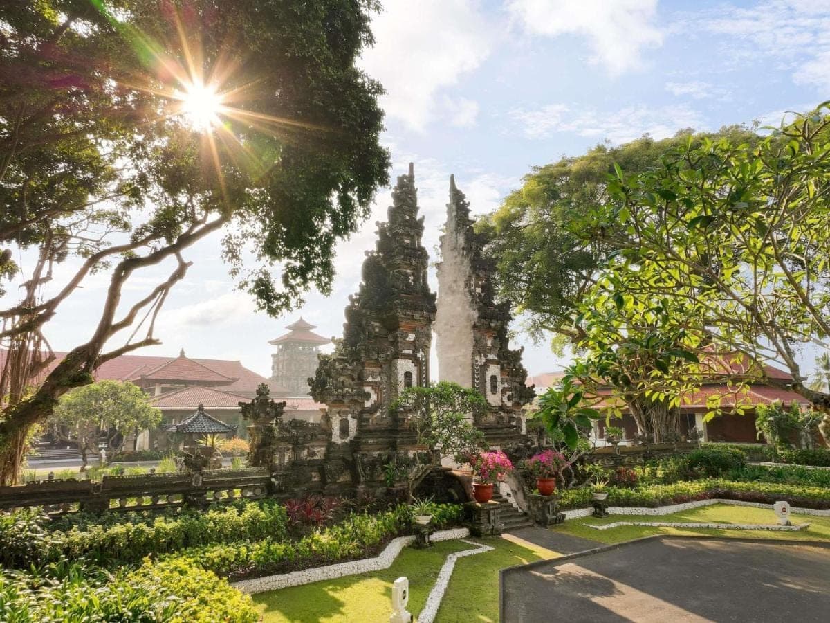 a temple in the middle of a park with trees at Nusa Dua Beach Hotel and Spa - Handwritten Collection in Nusa Dua