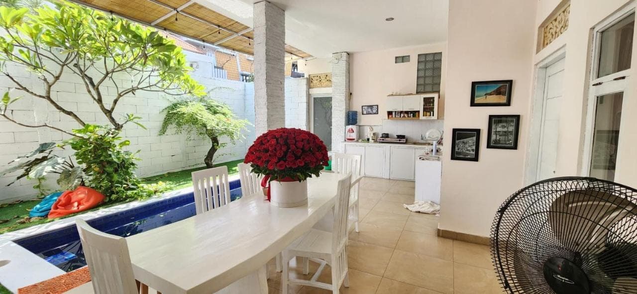 a kitchen and dining room with a large window with an aquarium at Capricorn Villa in Seminyak