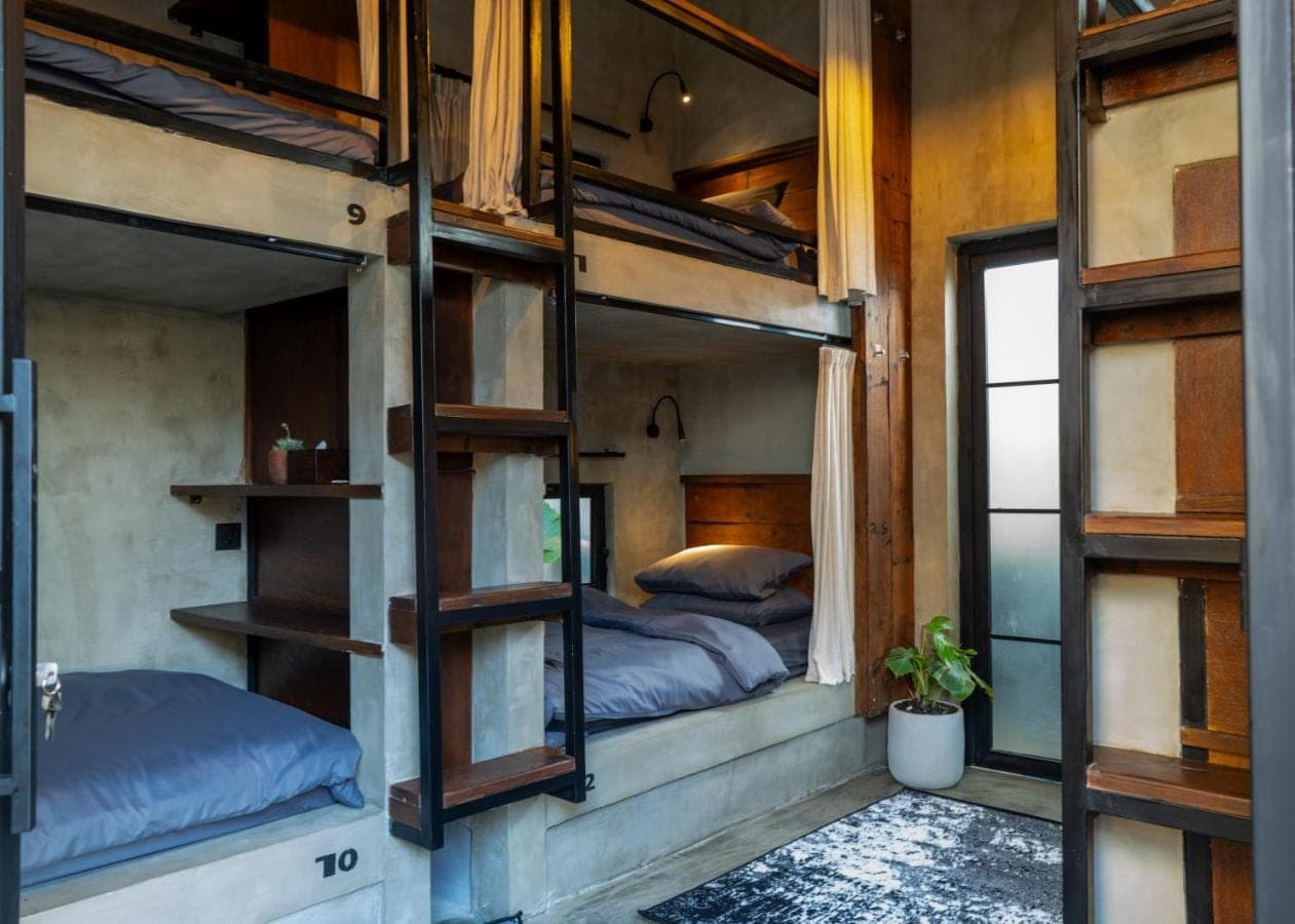 a room with two bunk beds and a window at Iron Wave Uluwatu in Uluwatu