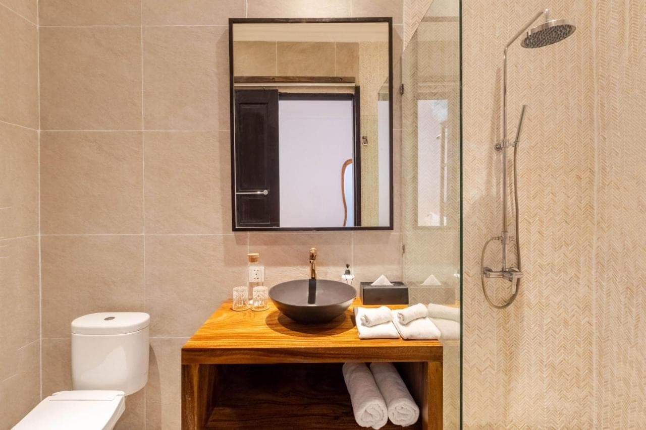 a bathroom with a sink and a toilet and a shower at Villa Gael by Pertama Stay in Seminyak